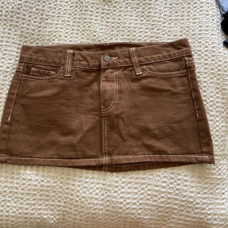 Jeans Material. Never Worn Casual Brown Lined Skirt, Trendy Brown Skort For Spring, Trendy Brown Skirt For Spring, High Waist Brown Skort For Spring, Brown Cotton Mini Skirt For Fall, Casual Brown Skort For Spring, Trendy Brown Lined Skirt, Brown Mini Skirt For Spring, Casual Brown Mini Skirt For Spring