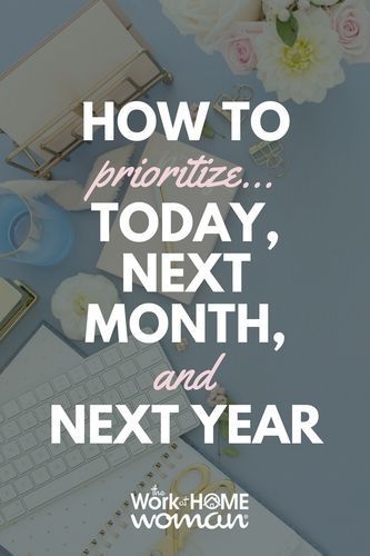 the words how to prioritize next month, and next year on top of a desk