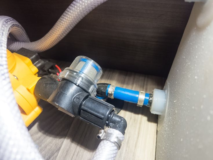 the inside of a water heater with hoses connected to it's outlet