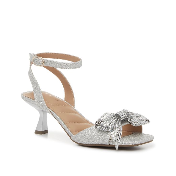 Kelly & Katie-Zaina Sandal You're sure to dazzle with this dainty style! The Zaina sandals from Kelly & Katie feature a classic silhouette, complete with trendy kitten heel and a modern square toe. Finished off with a rhinestone-covered bow that adds a sweet sparkle. Silver Kitten Heels With Ankle Strap, Silver Ankle Strap Kitten Heels, Silver Kitten Heels For Summer Parties, Chic Silver Kitten Heels For Party, Spring Gala Kitten Heels With Padded Heel, Glamorous Spring Kitten Heels With Ankle Strap, Glamorous Spring Formal Kitten Heels, Silver Kitten Heels With Heel Strap For Summer, Silver Low Heel Kitten Heels For Summer