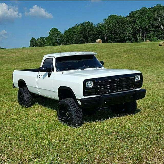 a white pick up truck parked in a field