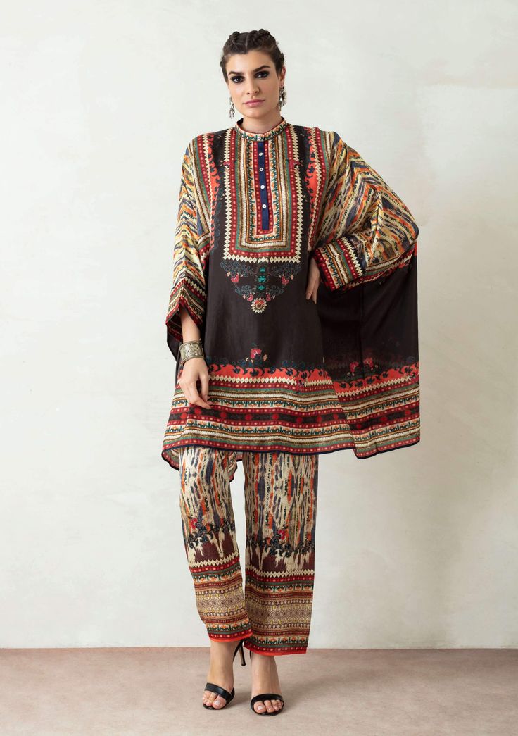 Editor's Note Band Collar Tunic With Cuffs & Printed Pallazo Pant With Front Belt Back Elastic Color: Black Fabric: Silk And Satin Care: Dry Clean Only About the Designer Rajdeep Ranawat, Indian artisan skills, and techniques are utilized to produce fine embroidered, sequinned, beaded motifs and designs. Further, original digital and block prints in generic western Silhouettes create a novel blend. Using the finest materials, weaves, metallic threads, beads, pearls, sequins and SWAROVSKI element Pallazo Pant, Payal Khandwala, Rajdeep Ranawat, Asymmetric Tunic, Twi Lek, Short Tunic, Tunics Online, Designer Kurti Patterns, Start Sewing