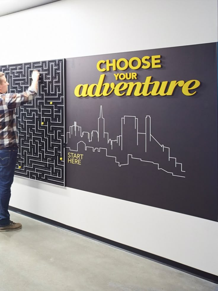 a man standing in front of a black and white sign that says choose your adventure