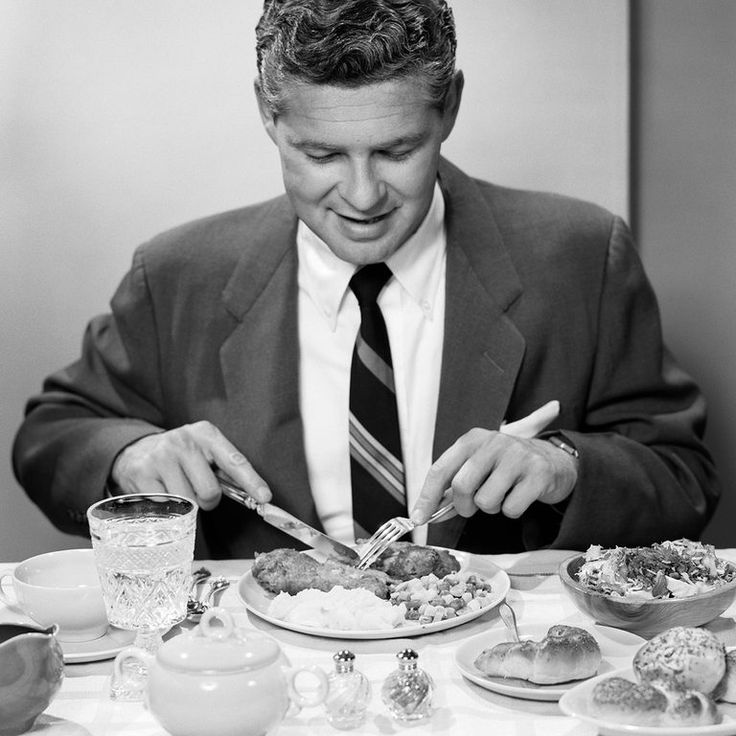 a man sitting at a table eating food