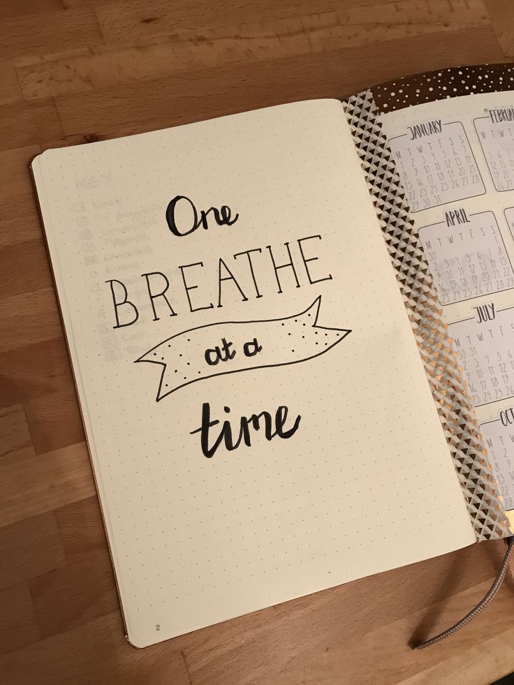 a notebook with the words one breathe at a time written on it