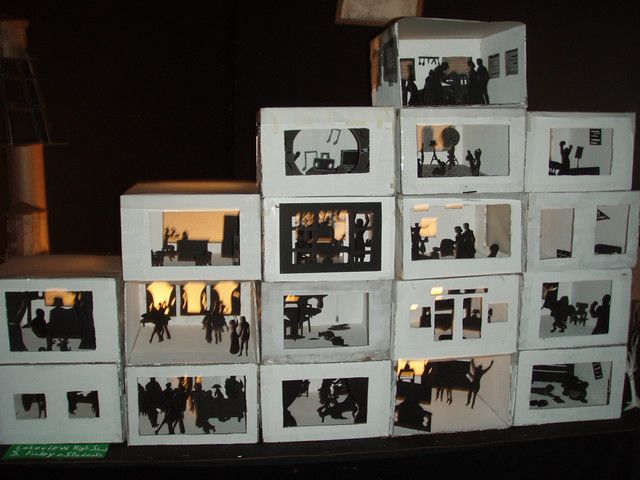 several white boxes stacked on top of each other with black and white photos in them