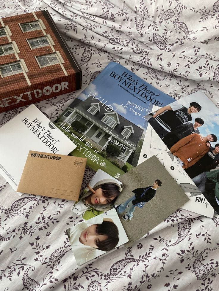 several books are laying on top of a bed