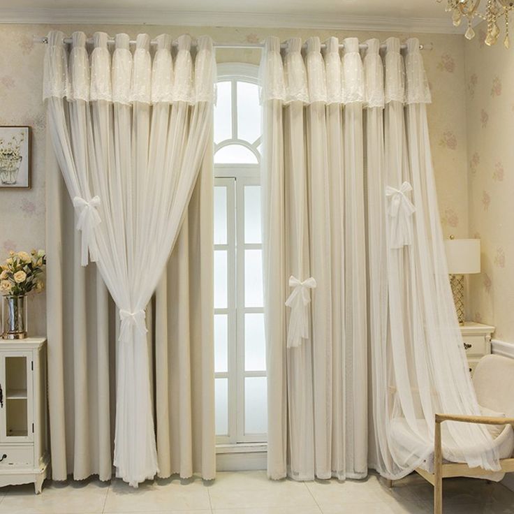 the curtains in this room are white and have bowknots on them,