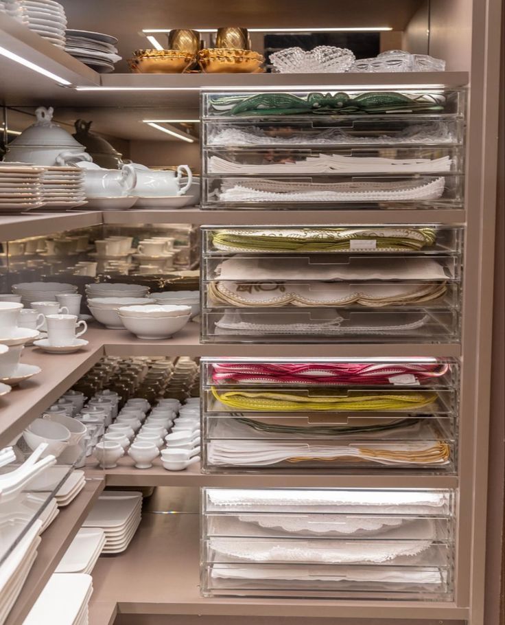 the shelves are filled with dishes and plates