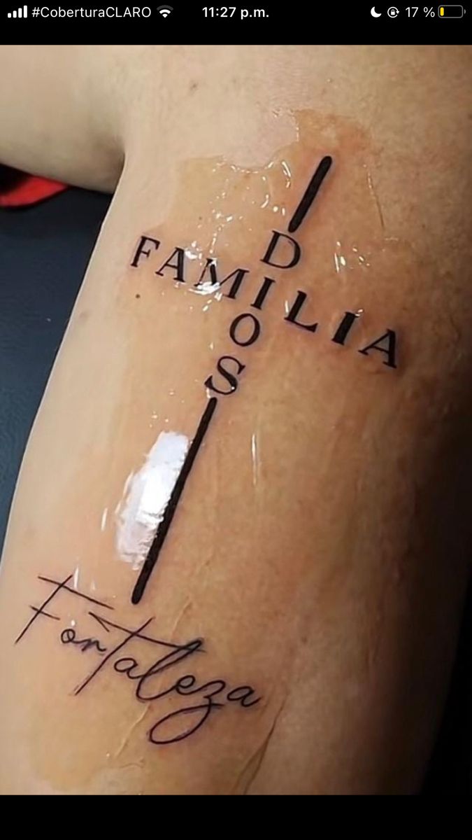 a person with a tattoo on their arm that reads, i am family 909