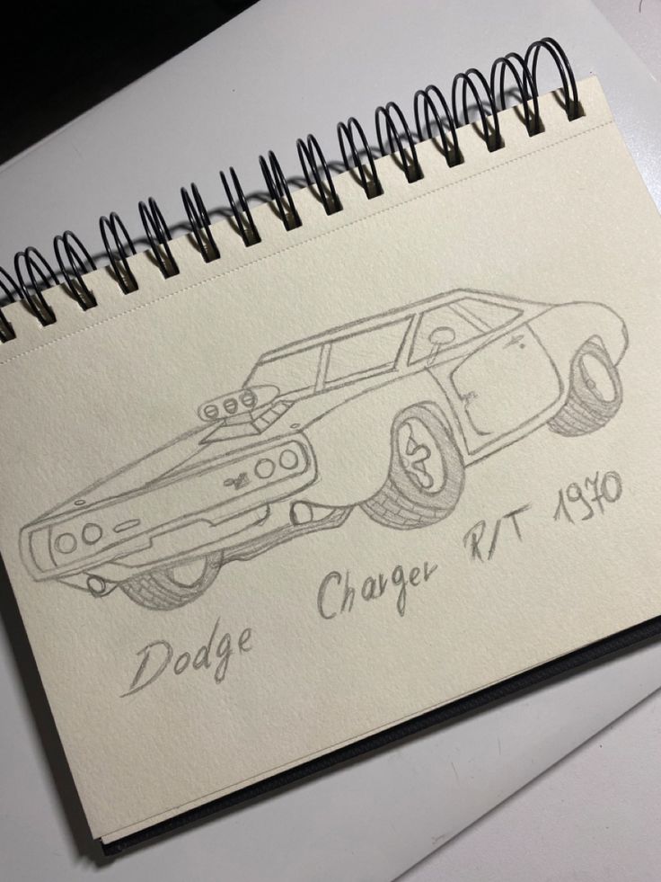 a drawing of a dodge charger r t 1970 on top of a notepad