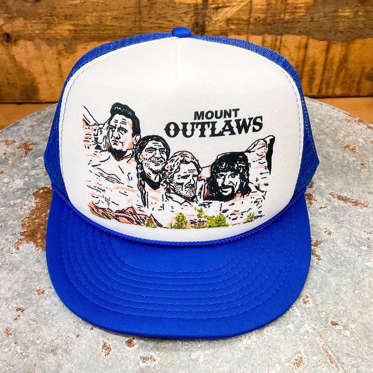 This exclusive trucker hat design from BiggieTexas features the "Mount Rushmore of Outlaw Country music": Willie Nelson, Waylon Jennings, Kris Kristofferson, and Johnny Cash.  This hat fits slightly smaller than our regular trucker hats. These adjustable snapbacks size up and down to fit most small to regular size adults, as well as youths. * Size: Small Adult / Youth * Crown height: 3-1/2", or Mid-Crown * Hat type: Structured * Snap type: Plastic * Trim: Braided Rope * Brim style: Curved This d Graphic Print Snapback Hats For Outdoor, Adjustable Outdoor Hat With Graphic Print, Adjustable Graphic Print Hat For Outdoor, Trucker Baseball Cap For Fan Gear, Trucker Hats With Graphic Print Snapback, Trucker Hat With Graphic Print And Flat Bill, Adjustable Trucker Hat With Graphic Print, Trucker Snapback Hat For Fan Gear, Outdoor Graphic Print Snapback Trucker Hat