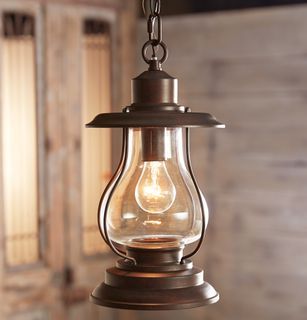 an old fashioned light hanging from a chain