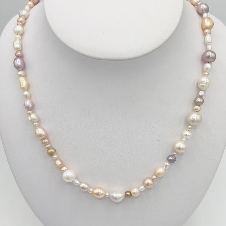 This is a Natural Freshwater Pearl necklace, stud earrings and bracelet set. These perfectly-imperfect baroque pearls are a blend of very light colored pastels, including pink, grey, white and gold. They would make a wonderful addition to your jewelry collection and their neutral tones go with everything. The necklace has a hook clasp in Sterling with a puffed heart charm. The stud earrings are Sterling with rhodium over to prevent tarnish. Elegant Multicolor Jewelry With Pearl Charm, Elegant Multicolor Pearl Charm Jewelry, Pink Single Strand Baroque Pearl Jewelry, Elegant Multicolor Single Strand Pearl Necklace, Elegant Multicolor Pearl Necklace For Formal Occasions, White Single Strand Pear-shaped Jewelry, Elegant Multicolor Pearl Necklace With Charm, Elegant Multicolor Pearl Necklace Gift, Classic Pink Pear Shaped Jewelry