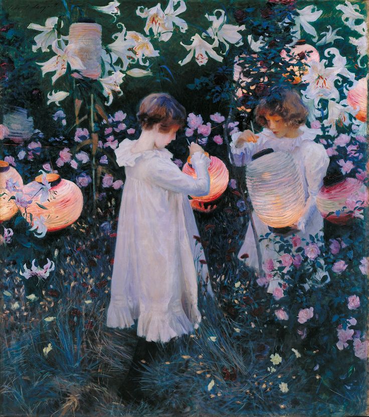 an image of two women in the grass with flowers and lights behind them, one woman is holding a lantern