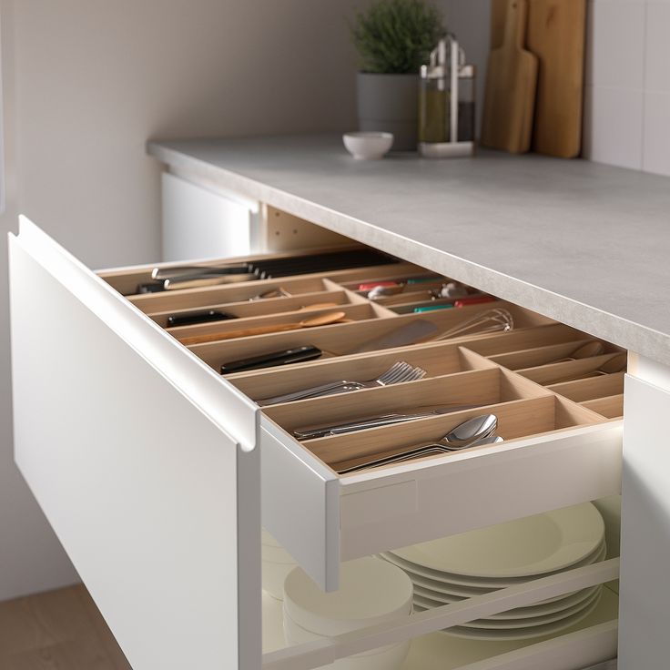 an open drawer with utensils in it