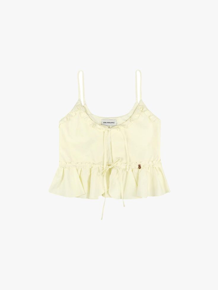 This is a trendy and feminine bustier by PINK PINEAPPLE that is made out of high quality and sturdy material. With casual mood of the design and clean look, it will give a trendy touch to your comfortable daily outfit.- Sturdy cotton 100% fabric- Frill detail on the waist and A line hem- PPA rose gold metal ornament detail Feminine Cotton Camisole With Adjustable Straps, Feminine Tops With Adjustable Straps For Daywear, Fitted Cotton Camisole For Daywear, Feminine Cotton Tops With Adjustable Straps, Chic Cotton Ruffled Tank Top, Chic Cotton Camisole For Summer, Chic Summer Cotton Camisole, Feminine Cotton Tank Top With Ruffles, Fitted Sleeveless Crop Top For Daywear