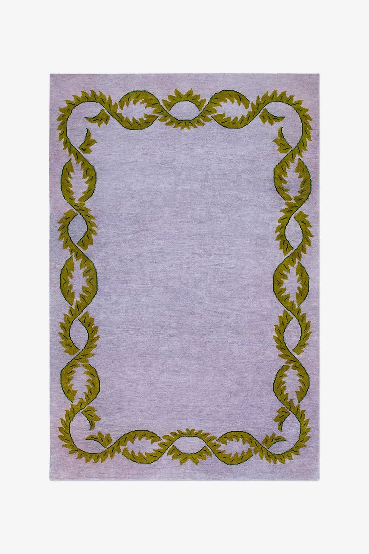 a purple and green rug with an ornate border