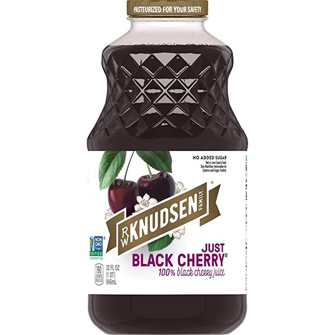 a bottle of black cherry juice on a white background