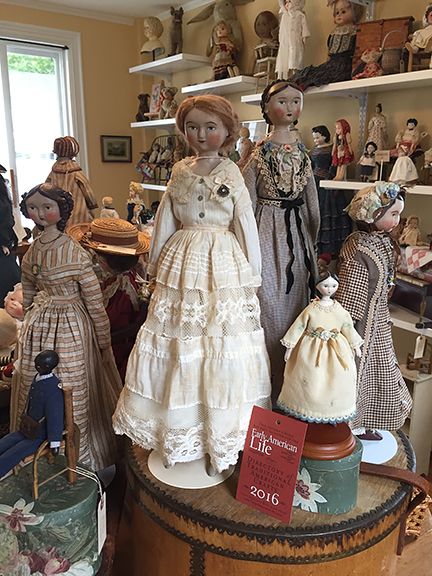 many dolls are on display in a room