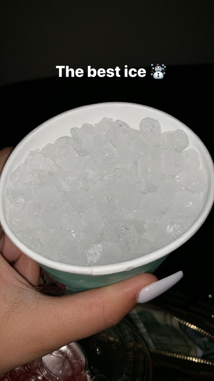 a person holding a bowl filled with ice