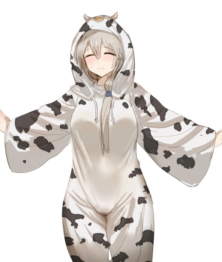 a woman in a cow costume with her arms spread out and eyes closed, wearing an animal - print hoodie