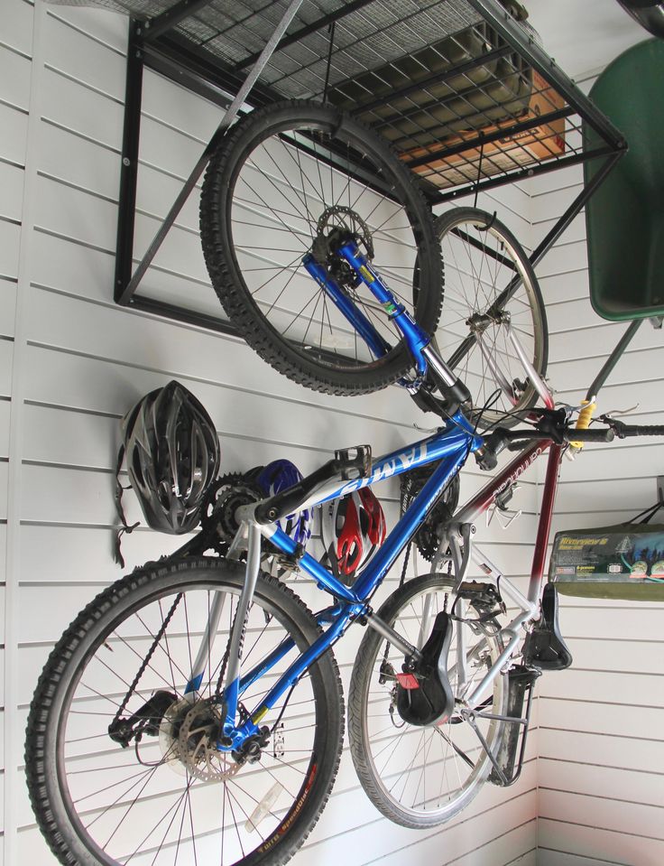 a bicycle hanging from the ceiling in a garage