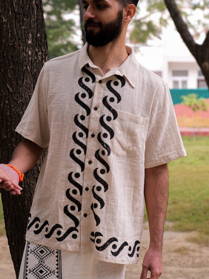 Add a touch of boho and free-spirited style to your wardrobe with the Manohara Shirt. Made from a blend of khadi cotton and jute fabric, this regular fit shirt features a unique Rajasthani handblock print on the front. Stay cool and comfortable in this minimal yet eye-catching piece. Trippy Shirts, Stylish Shirts Men, Boho Trends, Jute Fabric, Free Spirit Style, Festival Clothing, Unique Shirt, Shirt Button, Tee Dress