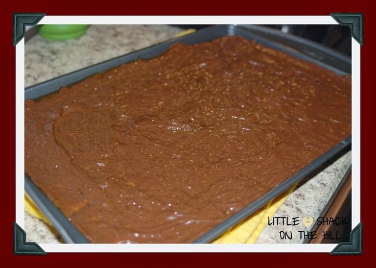 a pan filled with brownie batter sitting on top of a counter