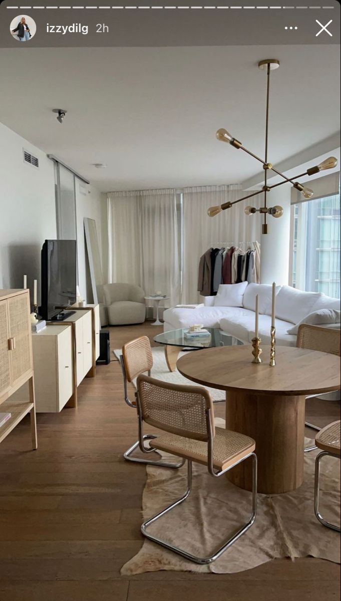 a living room filled with furniture and a flat screen tv on top of a wooden table