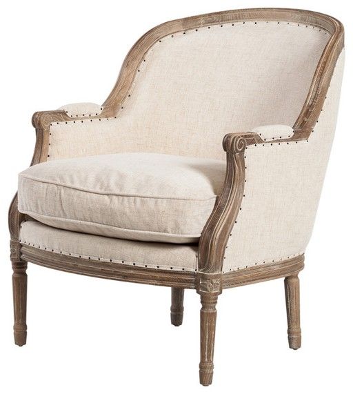 an upholstered chair with white linen and wood trimmings on the legs