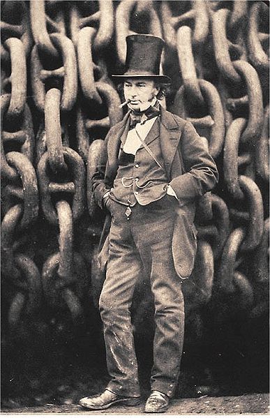 an old photo of a man standing in front of chains