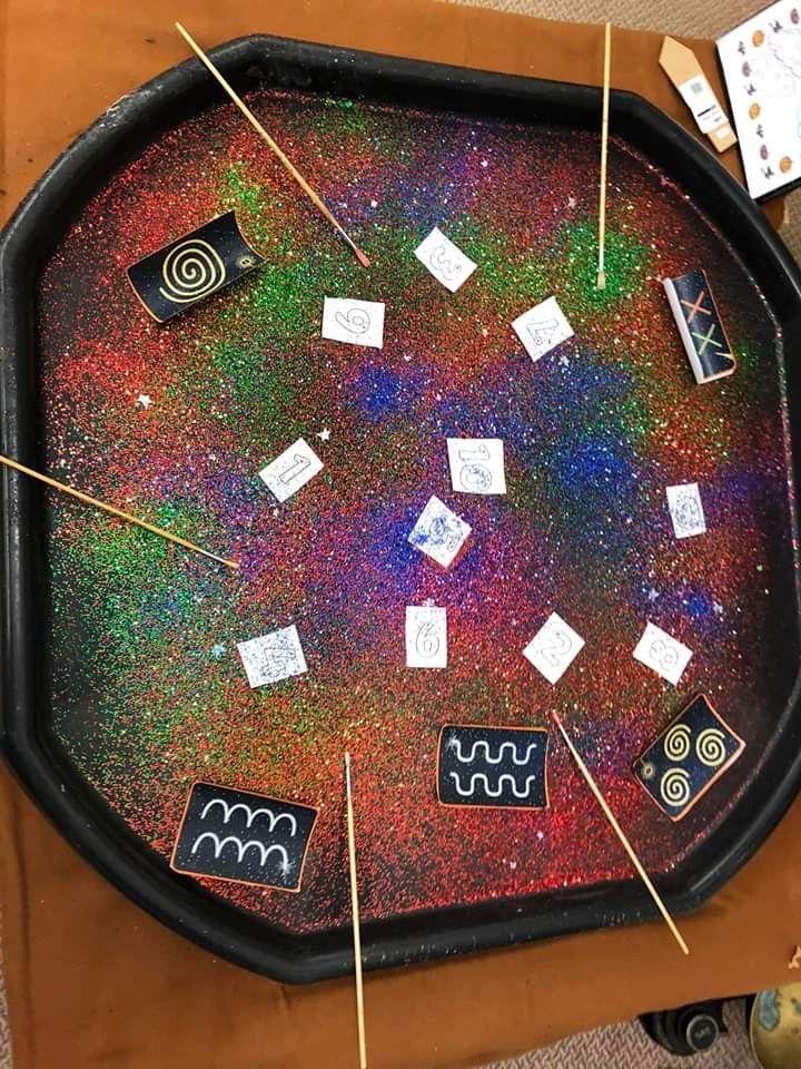 a black tray with different types of stickers and magnets on top of it