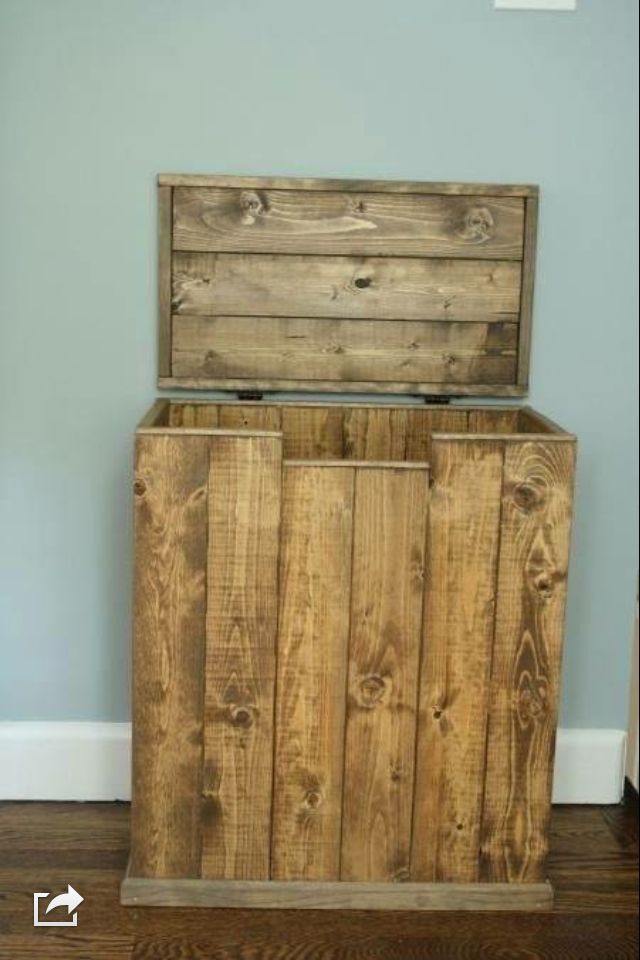 a wooden box sitting on top of a hard wood floor next to a blue wall