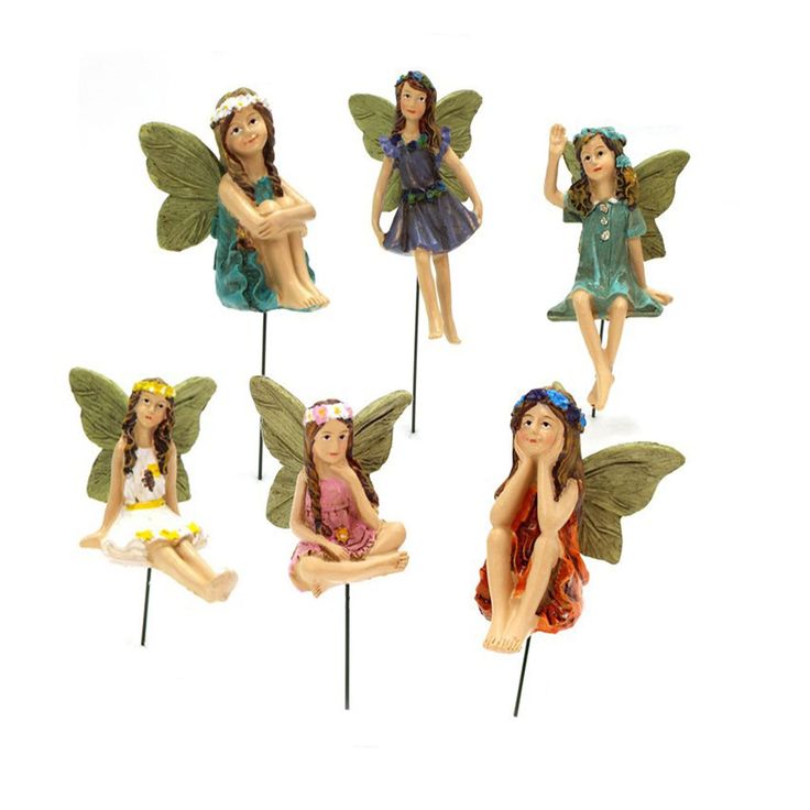 four fairy figurines sitting on top of each other