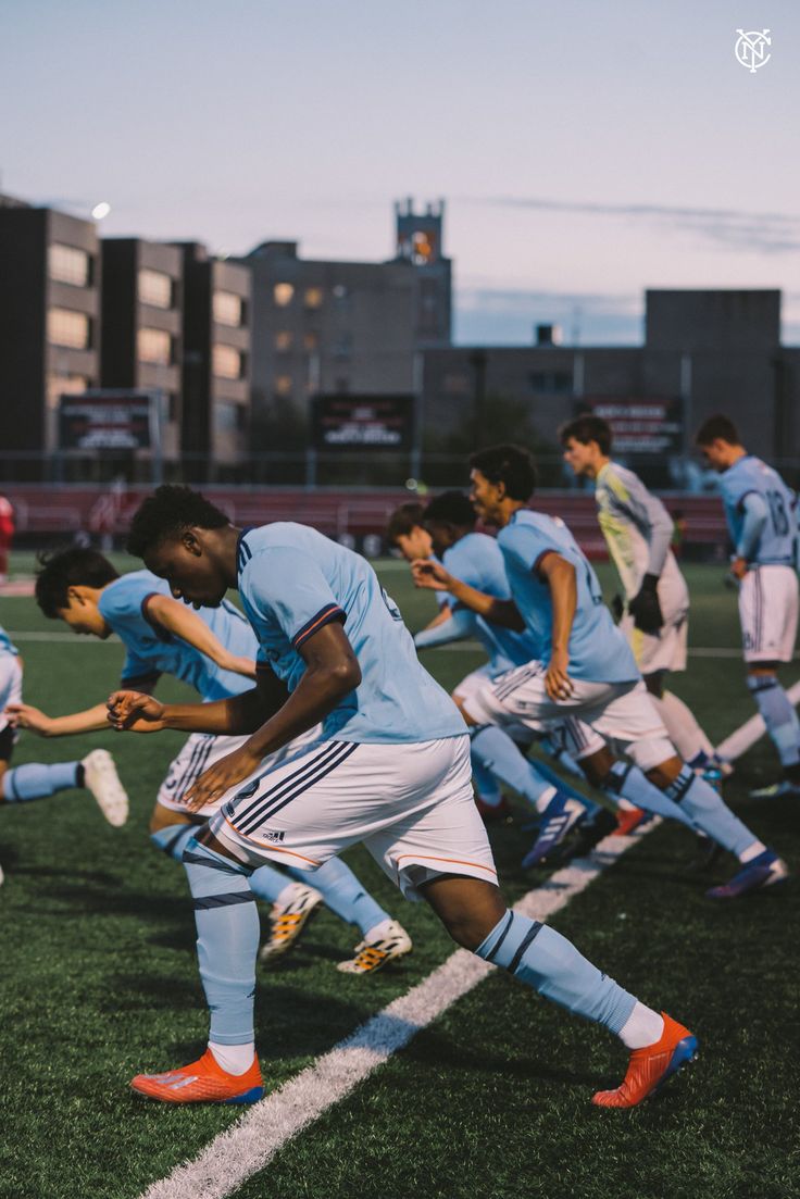 a group of young men playing soccer on a field