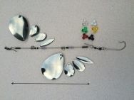 three different types of fishing lures on a white surface with an arrow in the middle