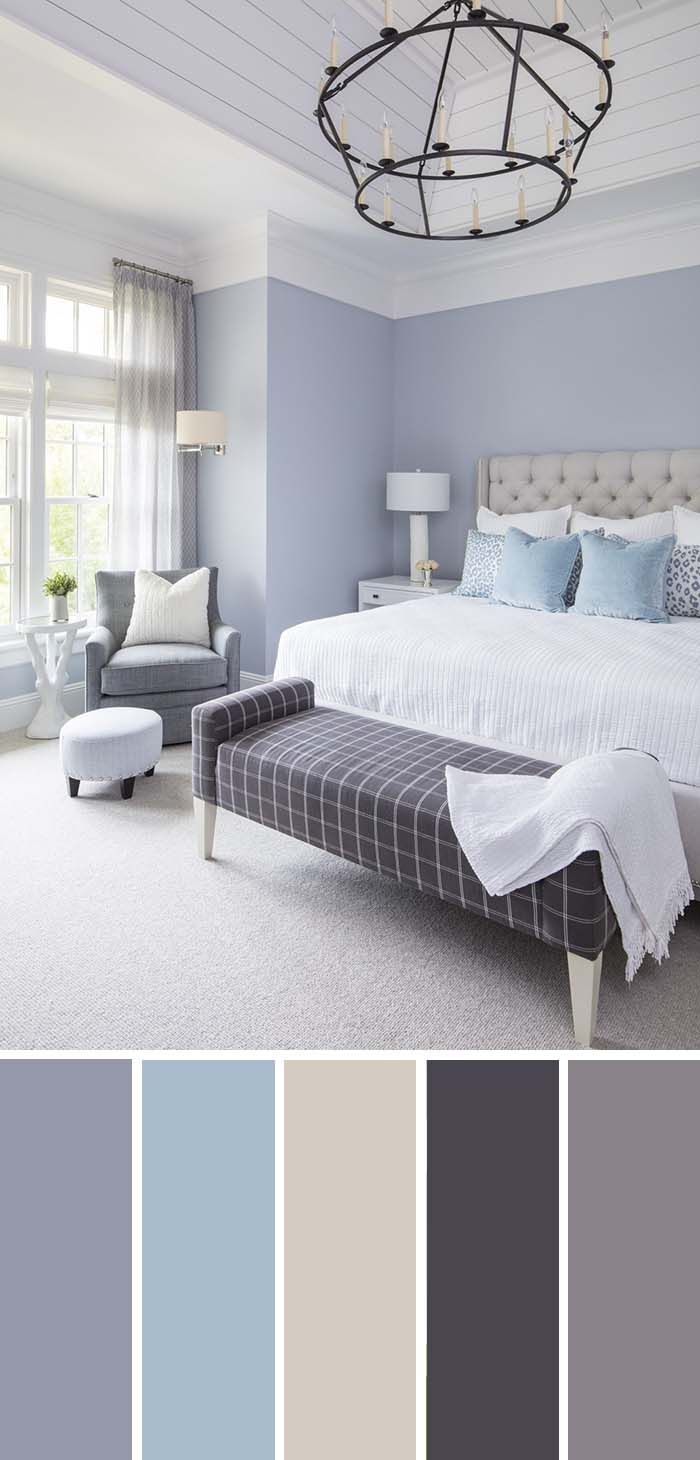 a bedroom with blue and gray colors in the walls, carpeted flooring and furniture