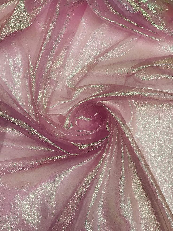 a close up view of a shiny pink fabric