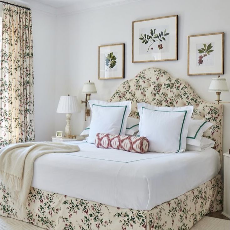 a bed with white sheets and pillows in a bedroom next to two lamps on either side of the bed