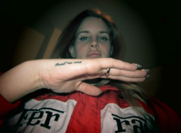 a woman with a small tattoo on her left hand