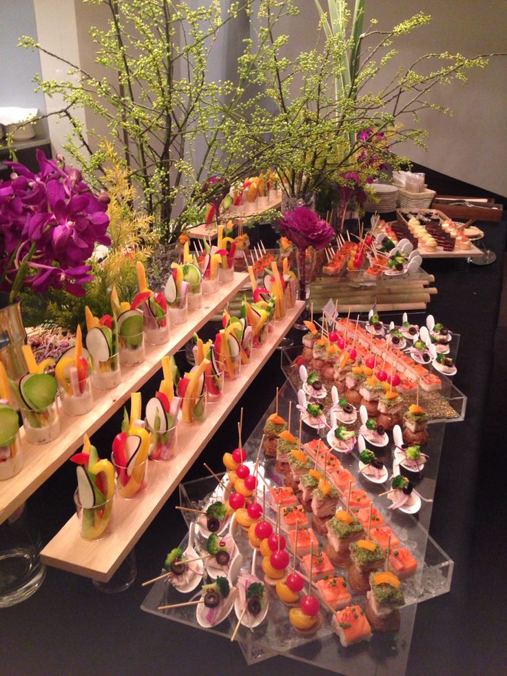 an assortment of appetizers are displayed on the buffet table