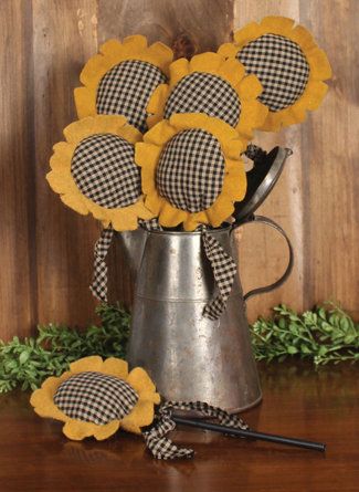 sunflowers in a watering can with gingham checkers on the side