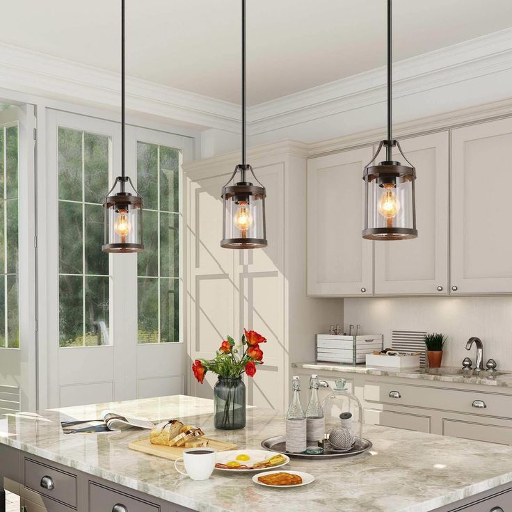 Well design by LNC lighting, the Laius collection features a wood accent tone cylindrical silhouette and slender adjustable down robs in a versatile solid finish, centered by a clear glass shade completes its charming modern flair. This timeless mini kitchen island pendant lighting with impressive cylindrical clean-lined frame wood tone finish, brings a hint of farmhouse influence as it illuminates any of your room like kitchen island, entryway, living room, dining rooms, foyer and corridor. LNC Glass Island Pendant Lights, Glass Kitchen Island, Black Modern Farmhouse, Kitchen Island Pendant Light, Lights Over Kitchen Island, Farmhouse Kitchen Island, Kitchen Island Pendant, Rustic Pendant Lighting, Farmhouse Pendant Lighting