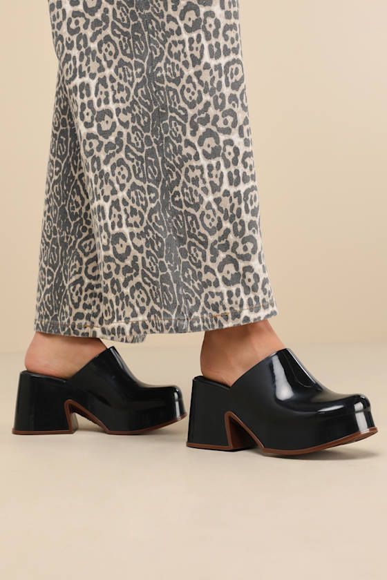 Let everyone know your style is one to watch with the Melissa Mia Black and Brown Platform Mules! Sleek, seamless rubber shapes these instantly iconic mules that have an almond-shaped toe and a flexible, clog-inspired upper. 1.25"" toe platform and chunky block heel boast a cool, brown-toned border to complete the look. Easy, slide-on design. Available in whole sizes only. 3. 5" block heel. Cushioned insole. Rubber sole has nonskid markings. Man Made Materials. Imported. Lulus | Mia Black and Br Platform Shoe, Platform Mules, Almond Shaped, Chunky Block Heels, Fashion Baby, Fall Shoes, Platform Shoes, Mules Shoes, Platform Heels