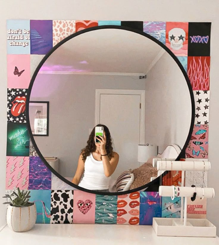 a woman taking a selfie in front of a mirror with colorful tiles on it