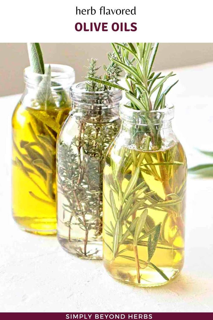 three jars filled with olive oil and herbs