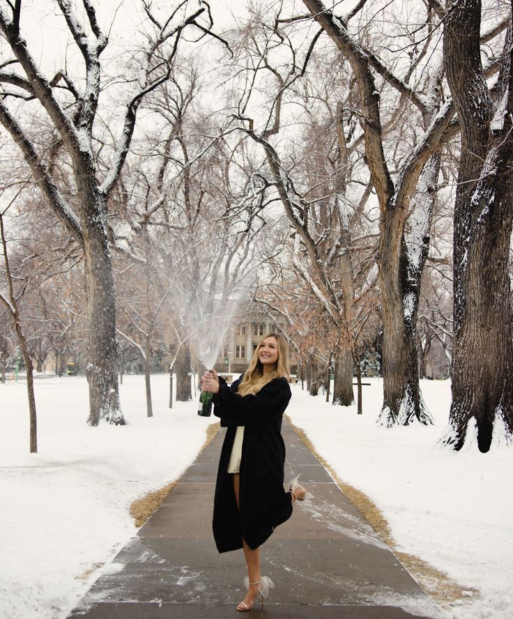 a woman standing on a sidewalk in the snow