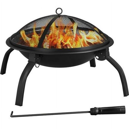 an outdoor fire pit with flames on the top and legs, sitting next to a black pole