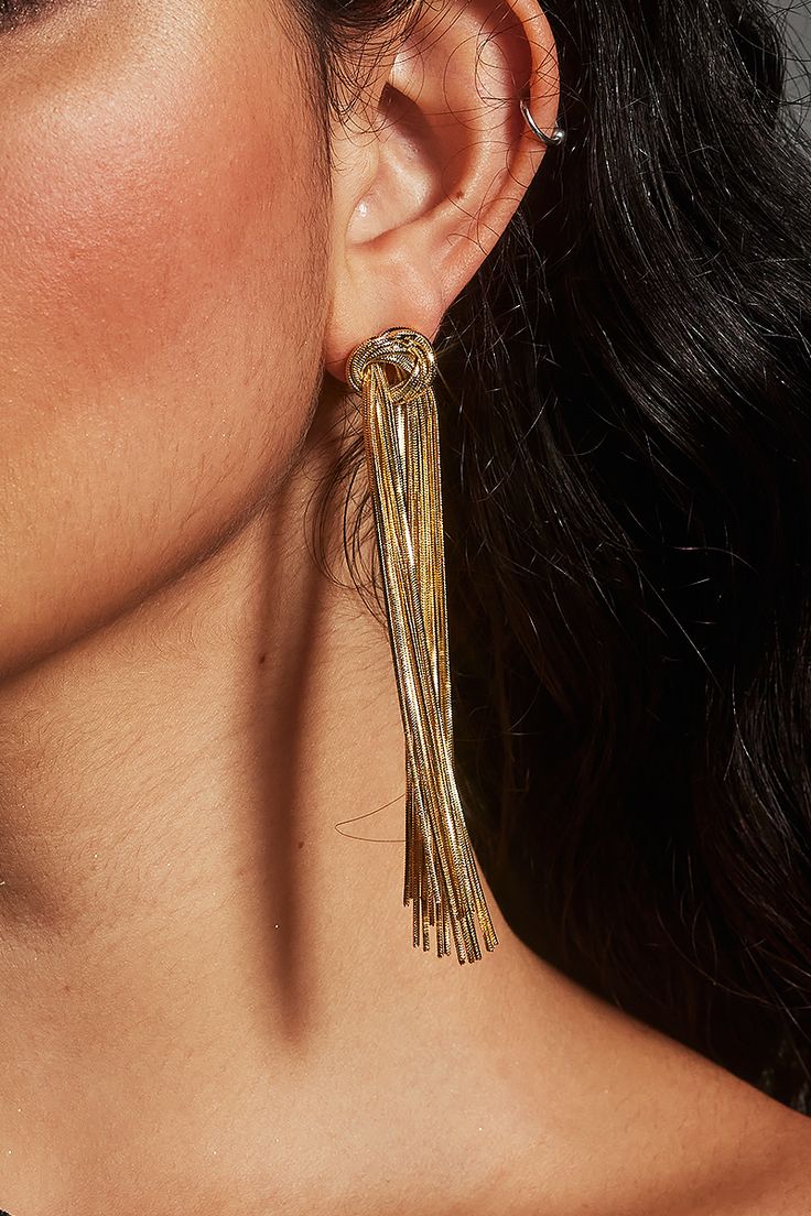 Add a touch of sophistication to your look with these stunning Knot Chain Tassel Earrings. The elegant knot design combined with cascading gold-tone chains creates an effortlessly glamorous effect. Perfect for formal events, nights out, or stylish everyday wear. Product Description: Knot Design: Intricately designed gold-tone knot for a refined statement look. Cascading Chain Tassels: Long, delicate chains for a dramatic yet elegant touch. Lightweight Construction: Comfortable to wear all day or Metal Tassel Drop Earrings For Party, Glamorous Metal Tassel Earrings For Party, Summer Night Out Metal Jewelry, Silver Tassel Earrings For Party, Silver Trendy Tassel Earrings For Party, Trendy Silver Tassel Earrings For Party, Adjustable Silver Tassel Earrings For Party, Trendy Gold Earrings For Evening, Summer Party Jewelry For Pierced Ears